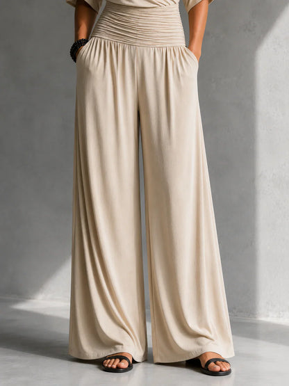 Elegante mono con efecto cruzado y pernera ancha
